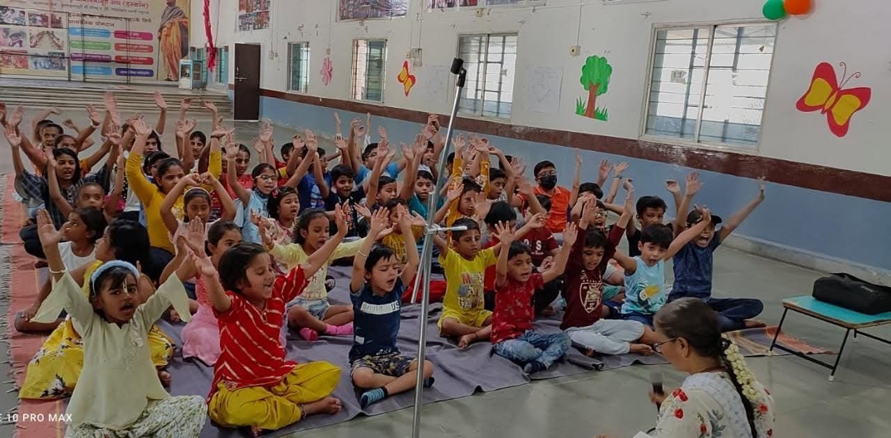 A large group of children enthusiastically participating in a Gopal Fun School session